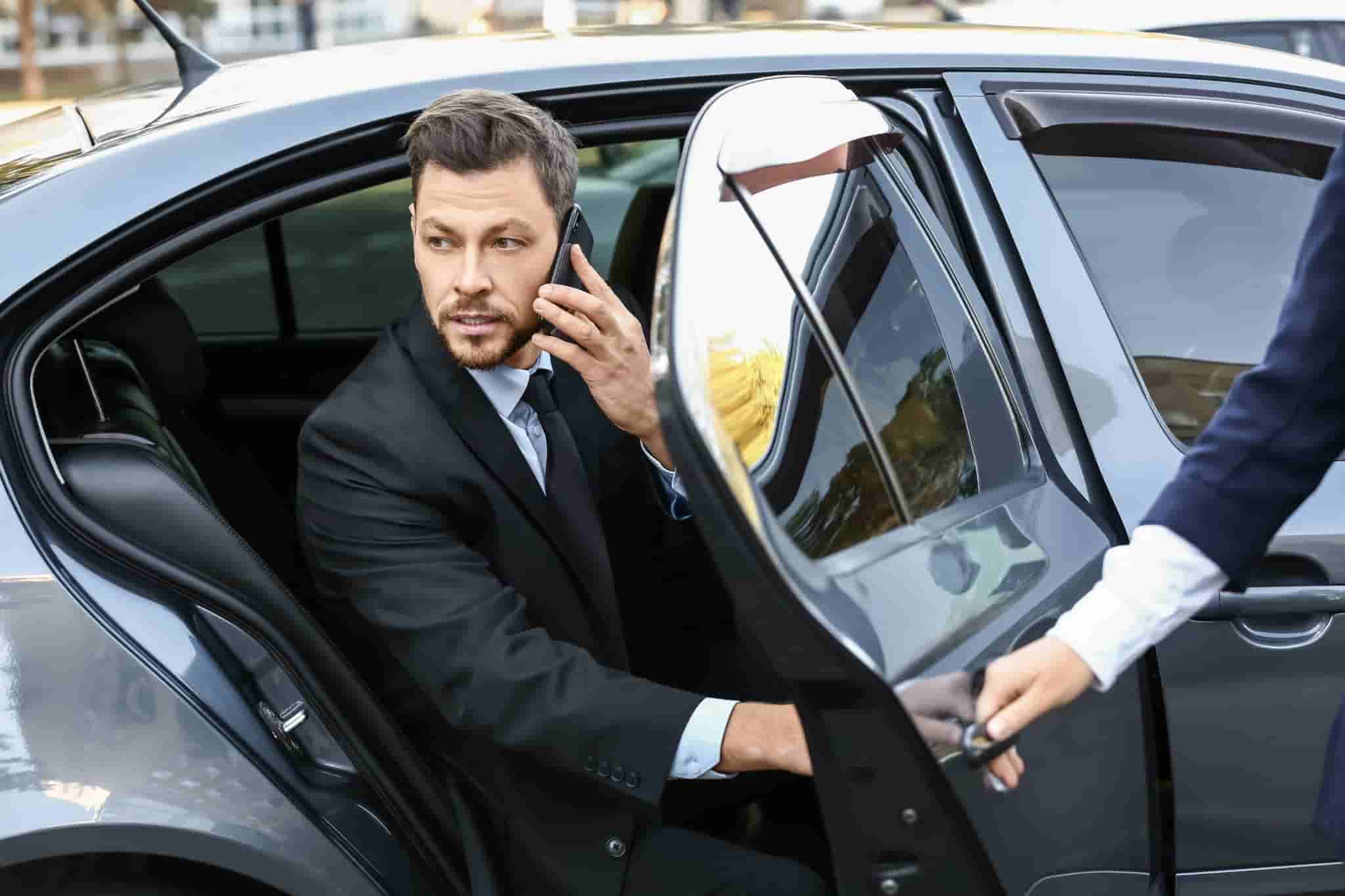 businessman getting out of luxury car 1